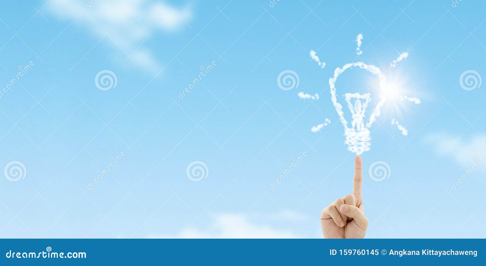fingertip touch white clouds in light bulb  with blue sky in background.