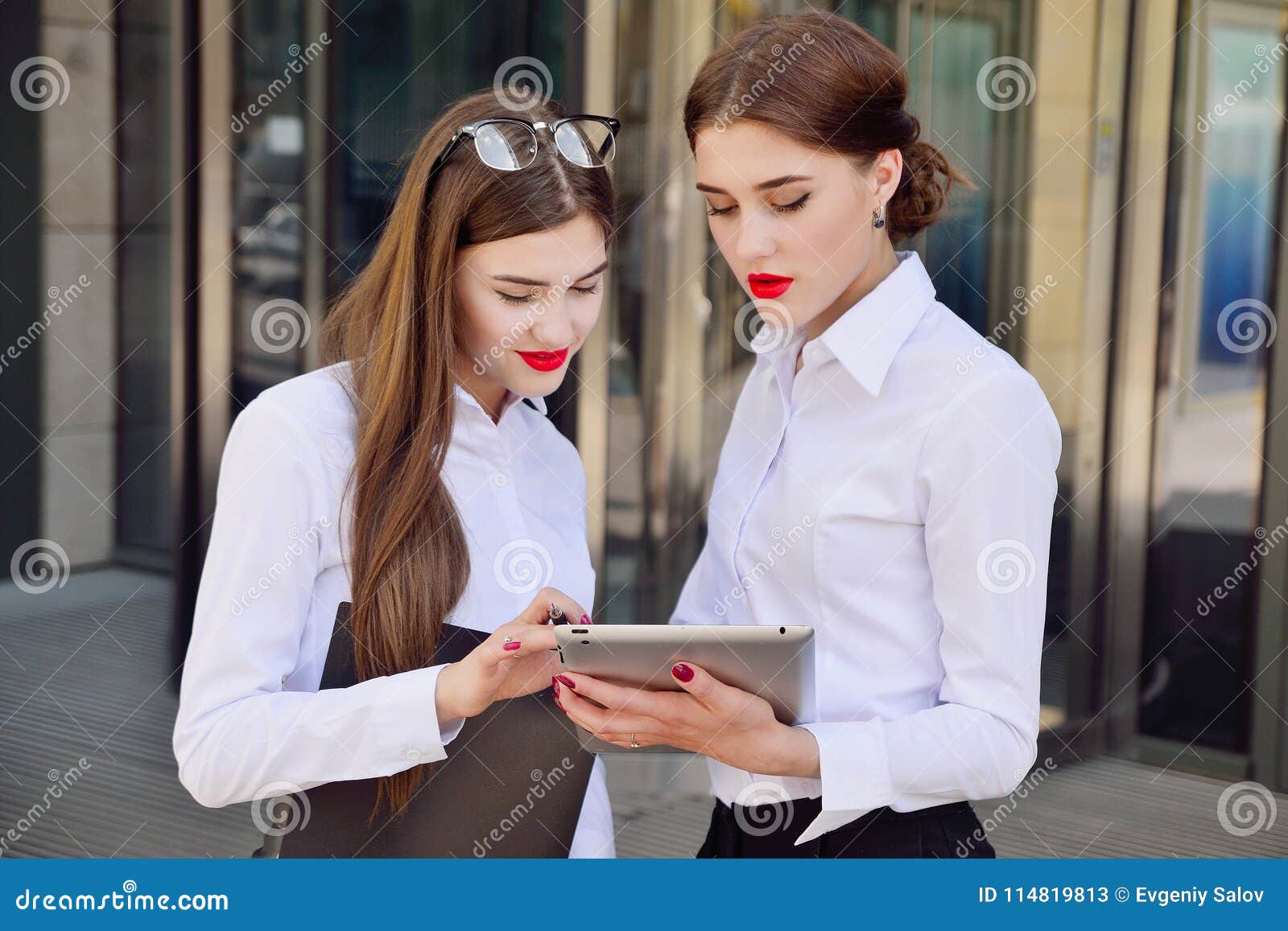 business lady. office staff. two young girls with electronic tab