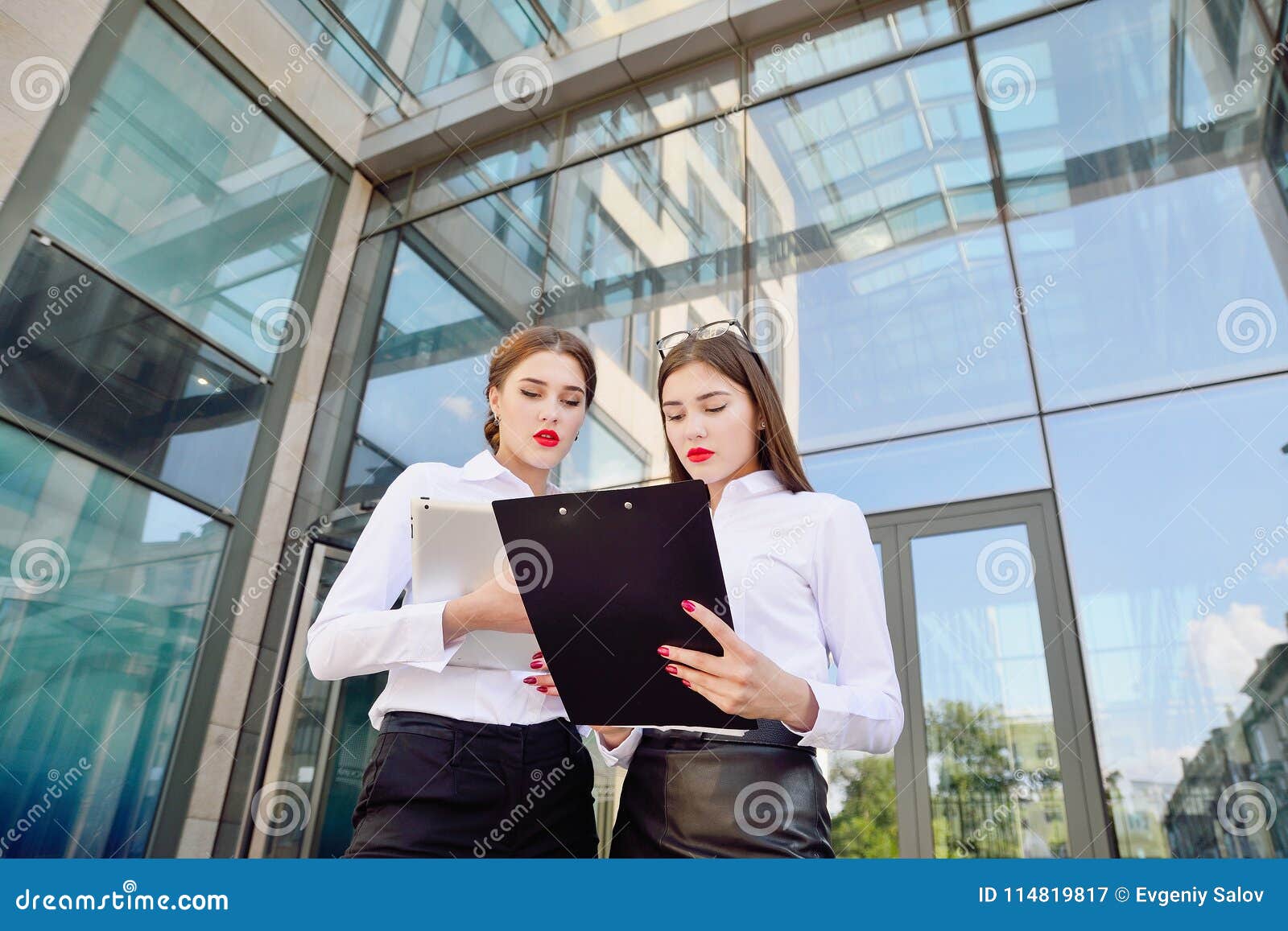 business lady. office staff. two young girls with electronic tab