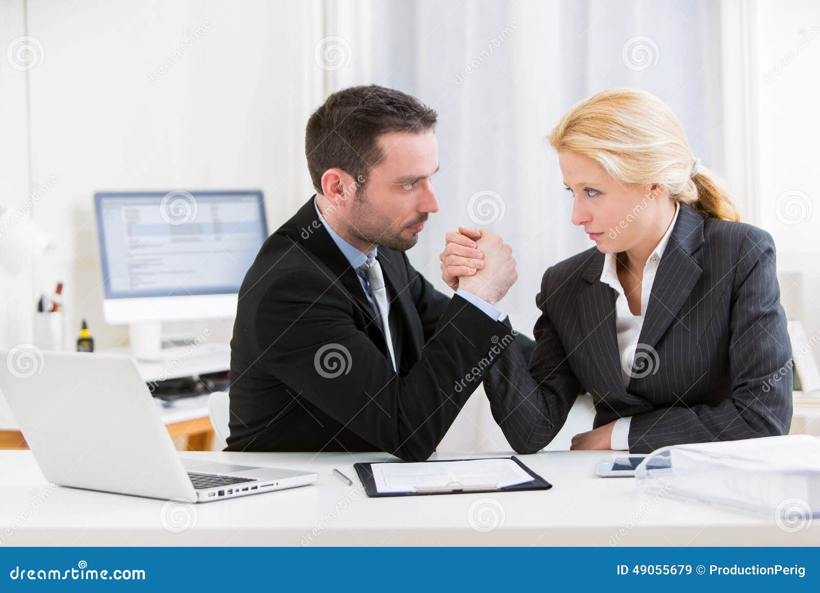 business man arm wrestling at the office