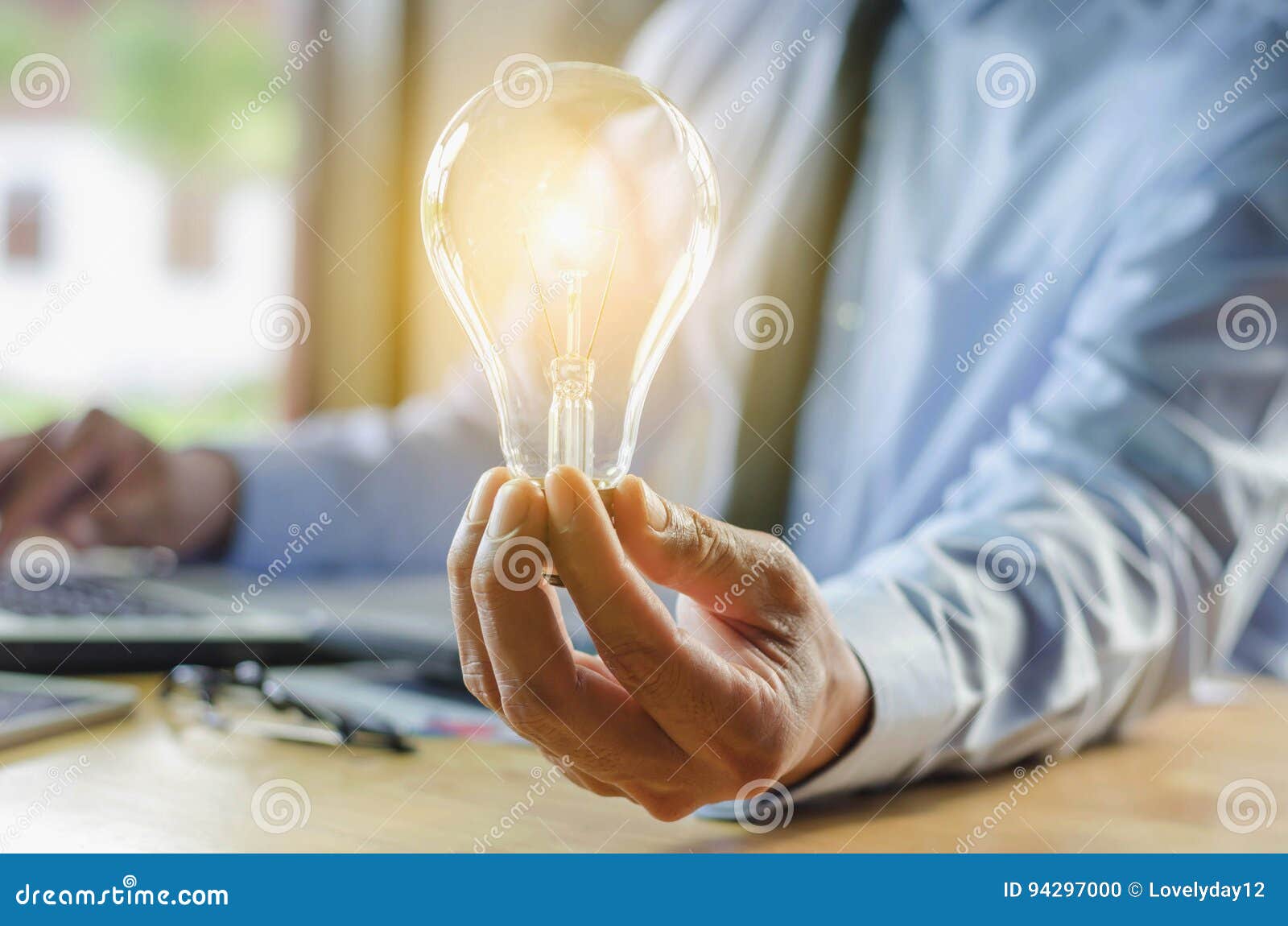 Business Man Holding Light Bulb, Concept Idea with Innovation Stock