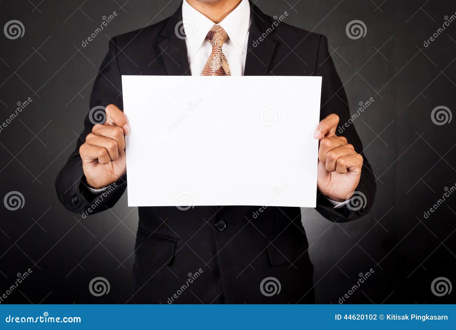 A Business Man Holding a Paper in Front of His Face Stock Photo Image