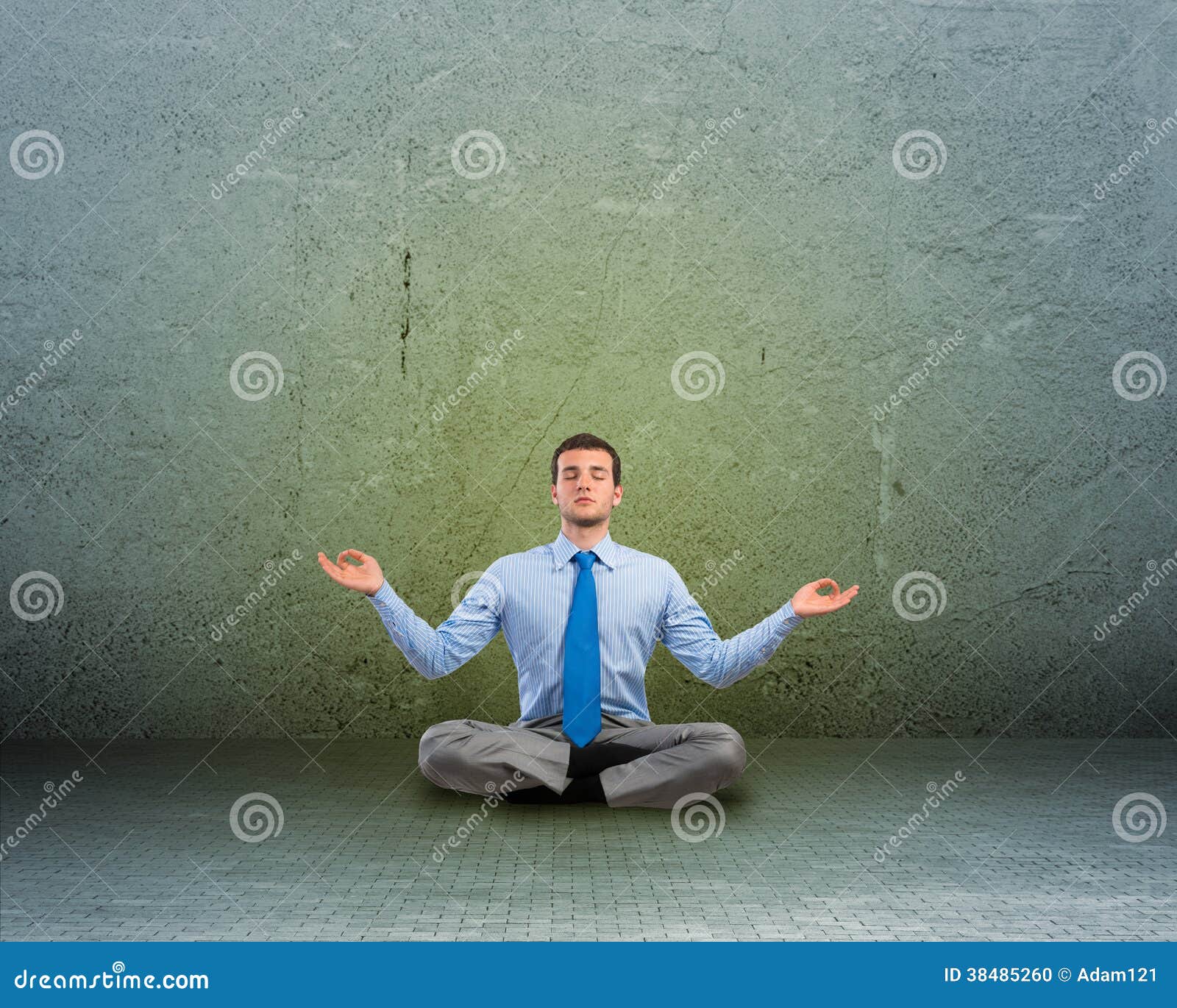 Image of a business man meditating on floor