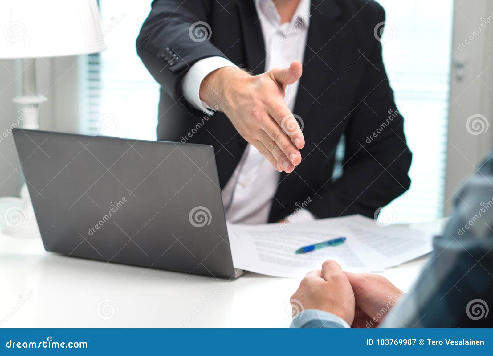 business man offer and give hand for handshake in office.