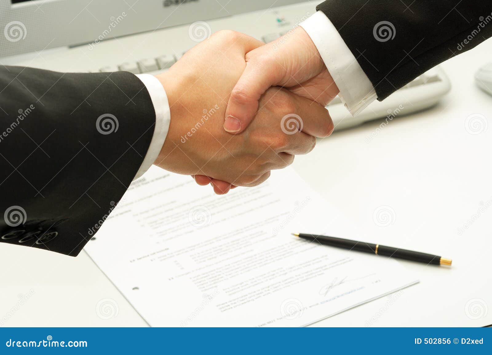 business man shake hands after signing a contract