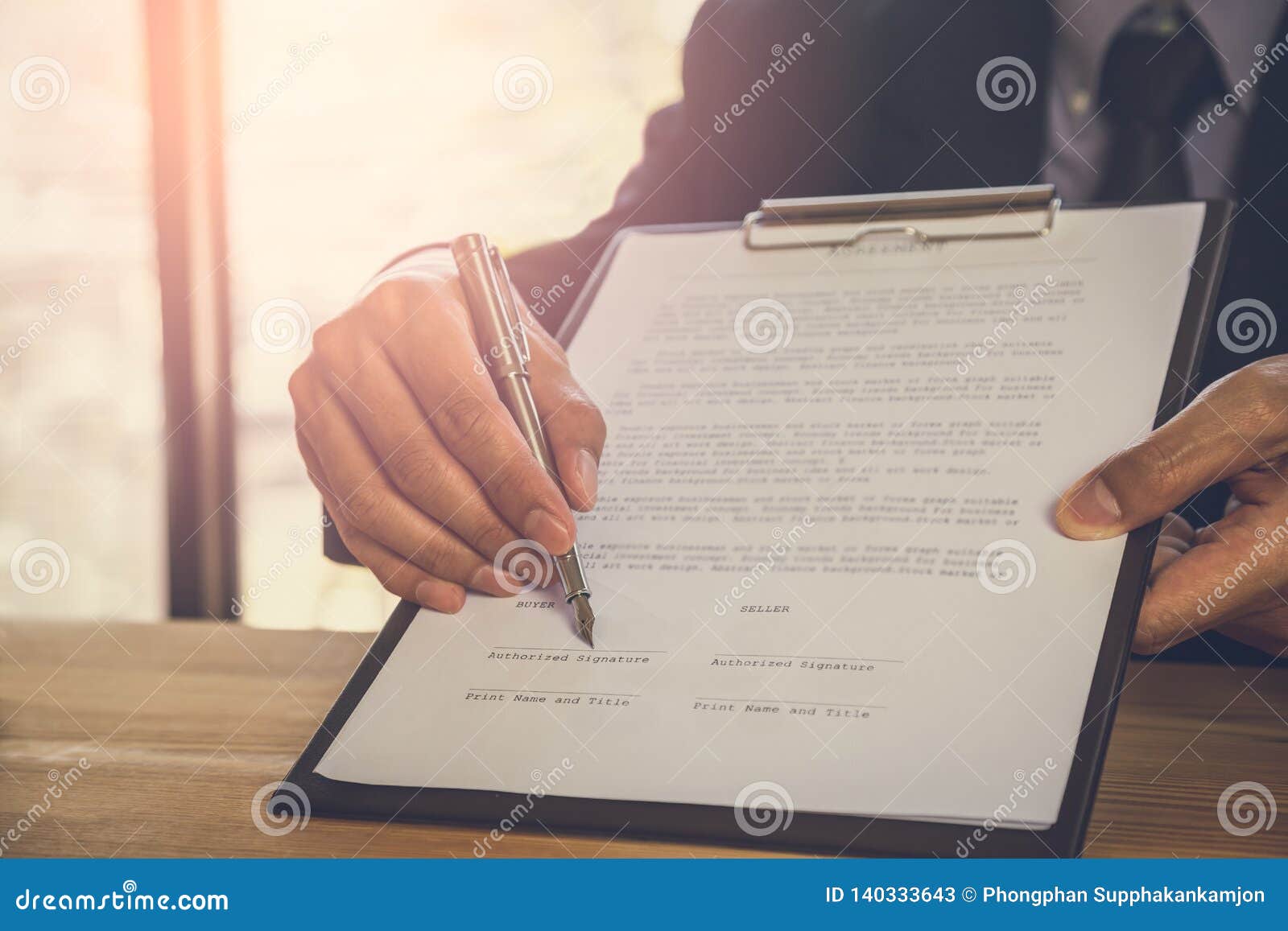 business man signing a contract. owns the business sign personally, director of the company, solicitor. real estate agent holding