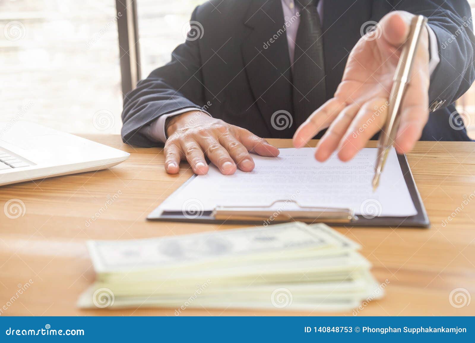 business man signing a contract. owns the business sign personally, director of the company, solicitor. real estate agent holding