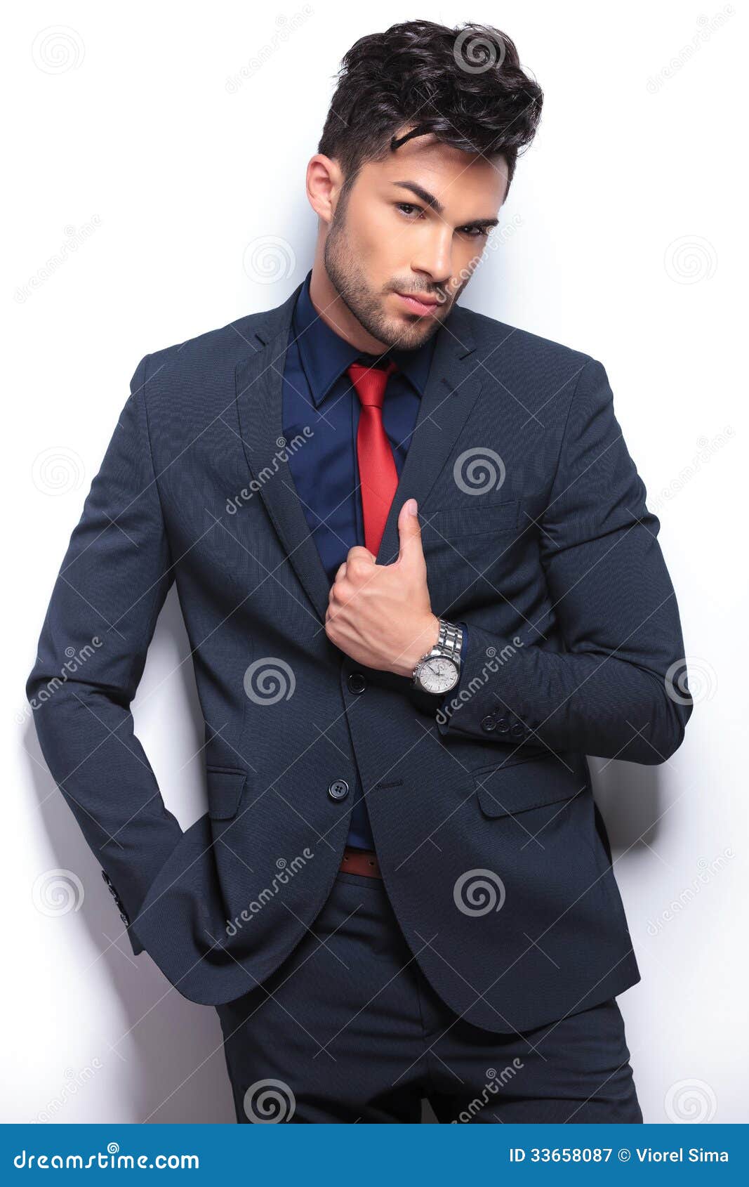 business man with tilted head and hand on lapel