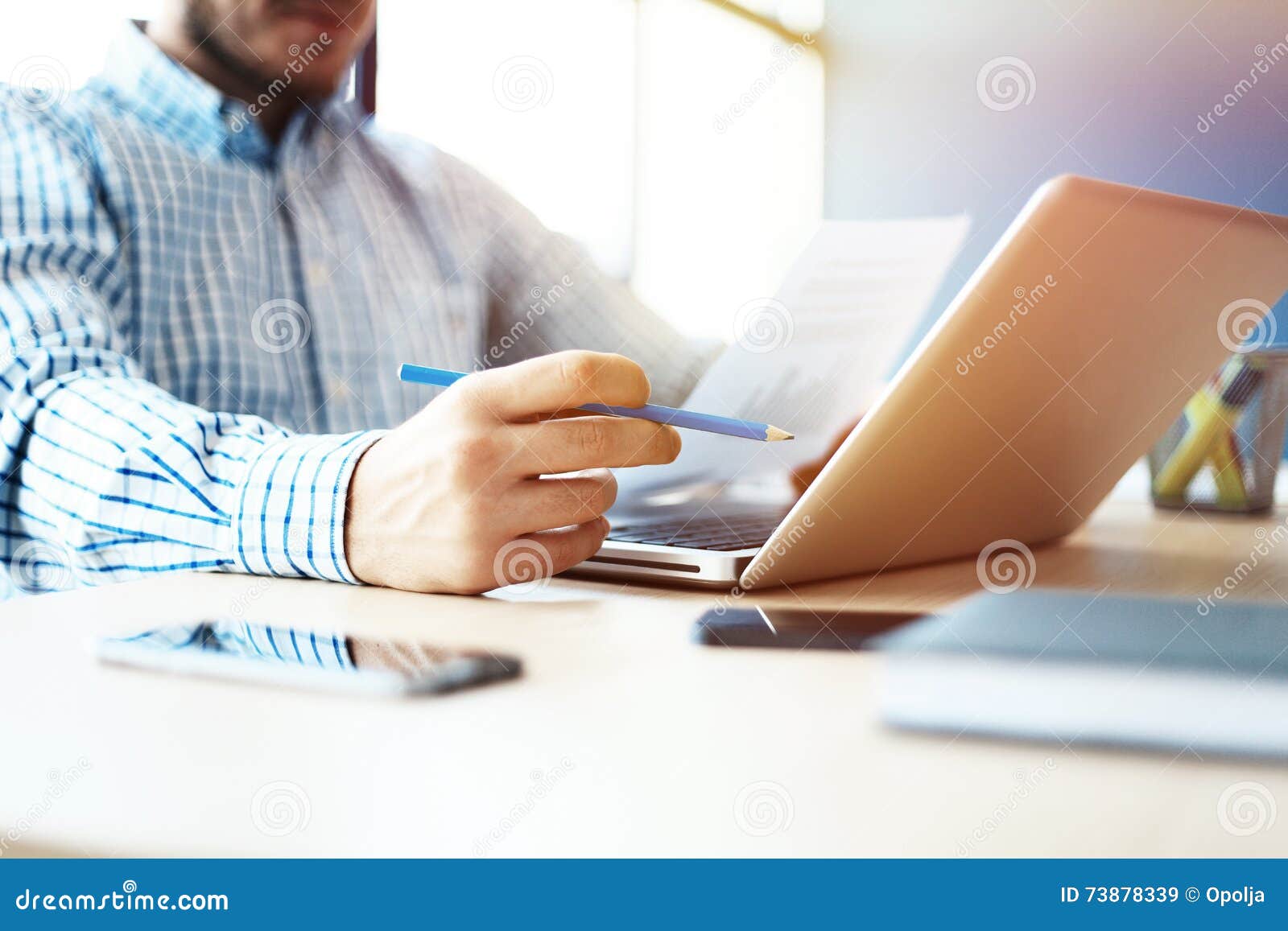 business man working at office with laptop and documents on his desk