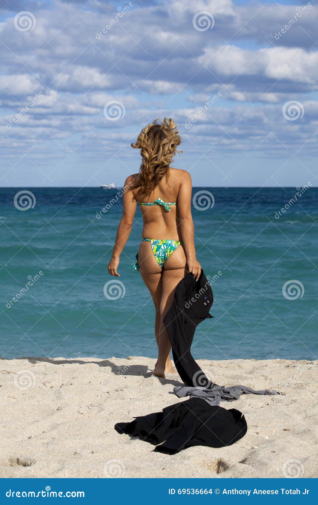 Woman In Bikini Taking Off Her Shorts While Walking On The Beach Stock  Photo, Picture and Royalty Free Image. Image 56412760.