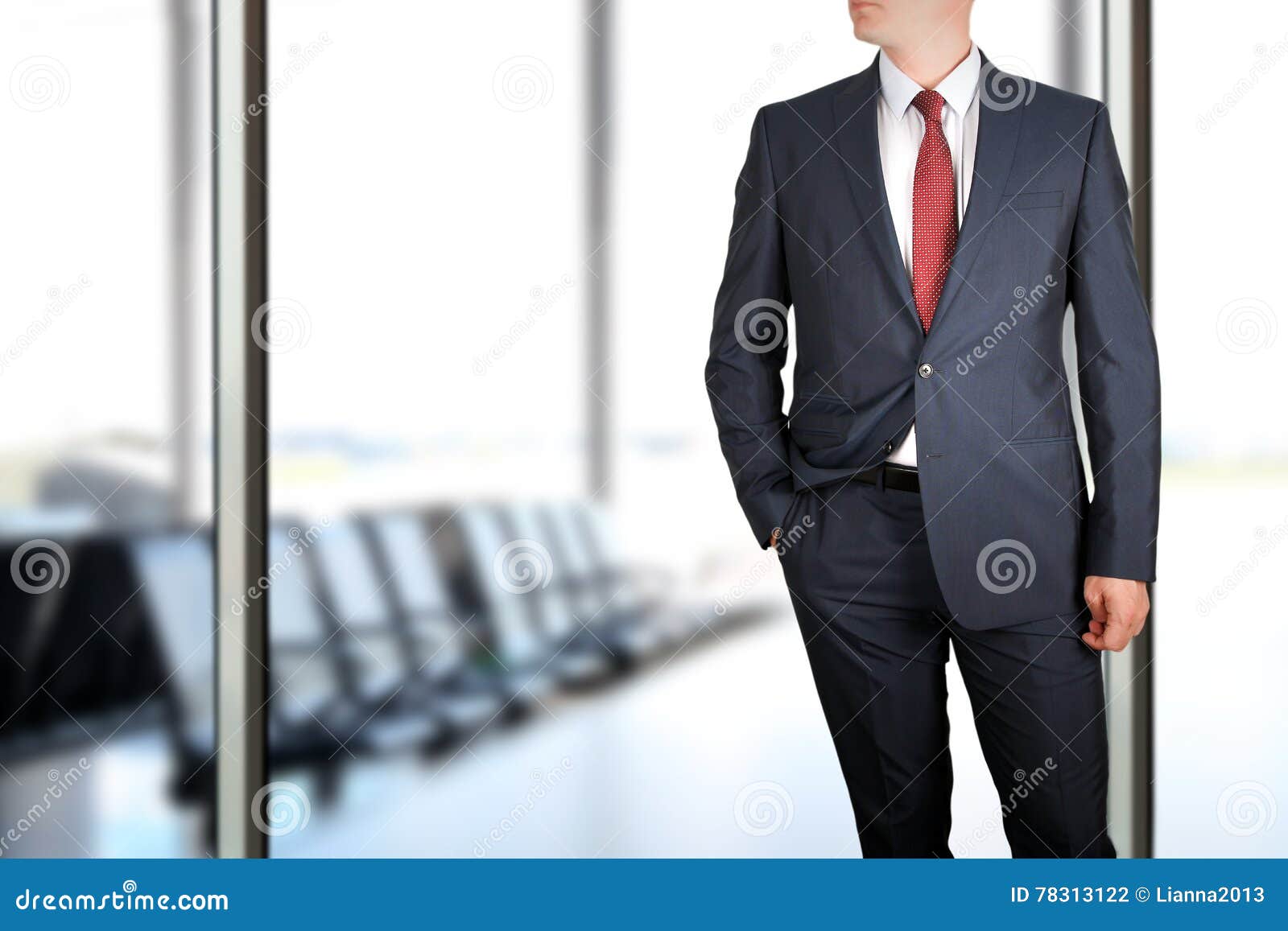 business and office concept - elegant young fashion buisness man in a blue/navy suit.