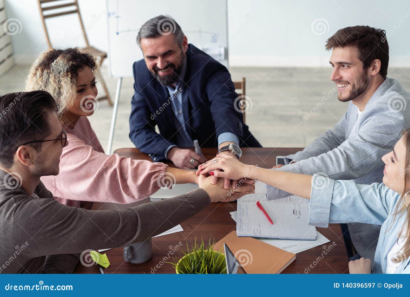 business partners hands on top of each other izing companionship.