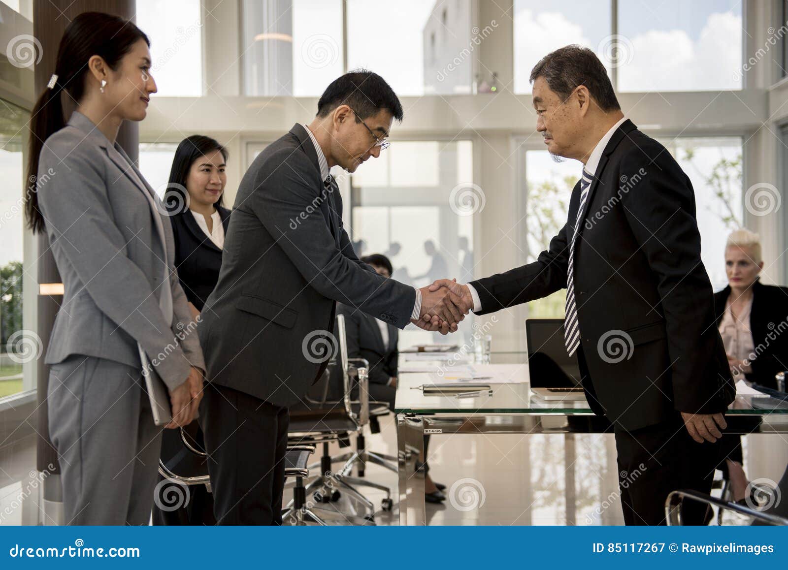 business partners introduction handshake bow concept