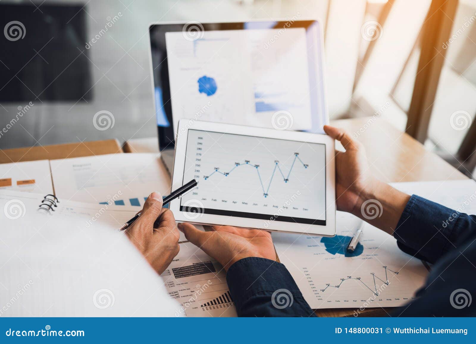 business partnership coworkers using a tablet to chart company financial statements report and profits work progress and planning