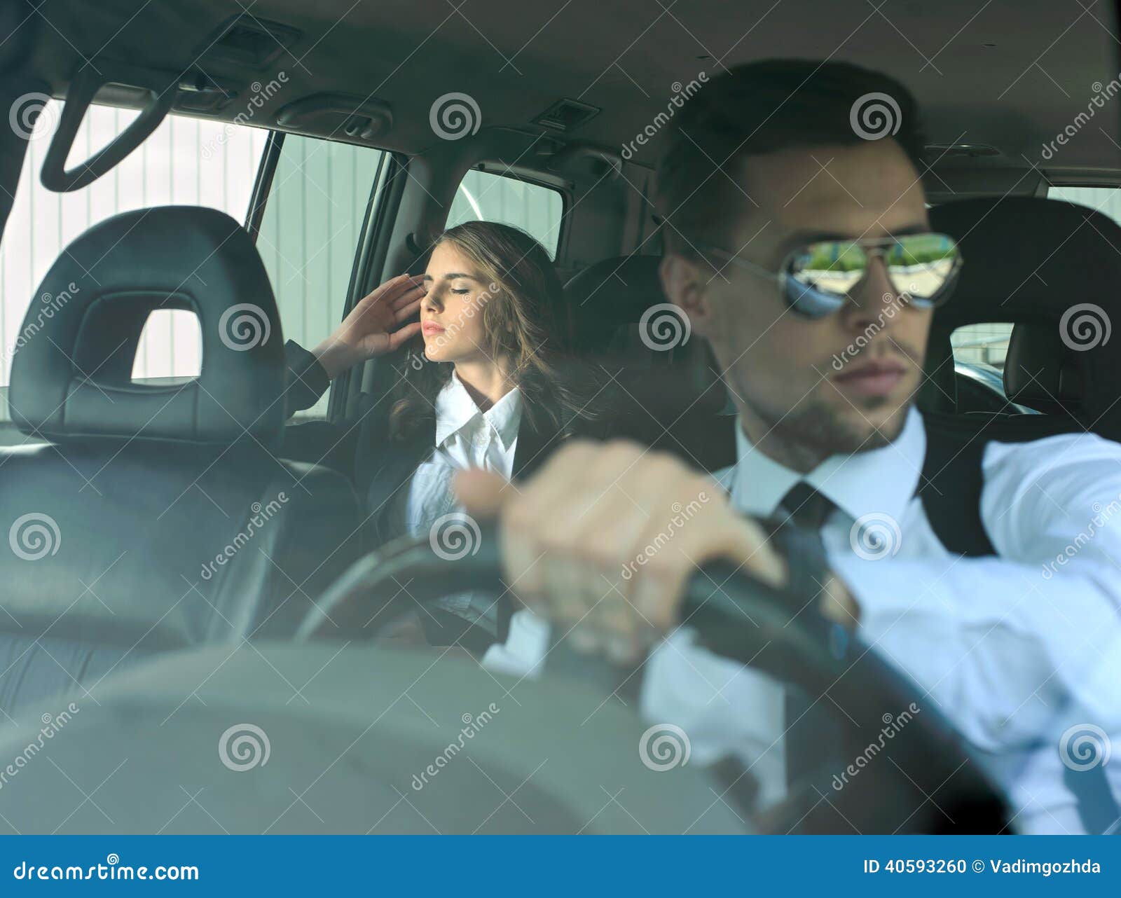 Business People In The Car. Businessman and business women traveling in the car