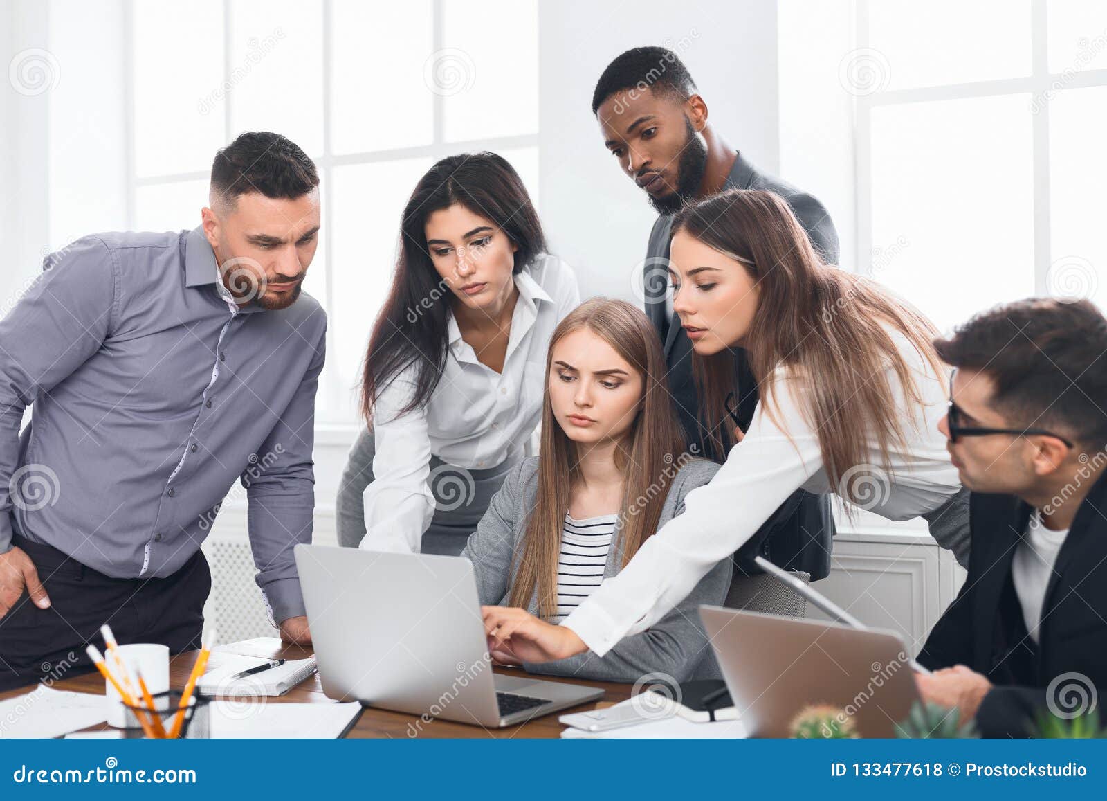 Business People Gathered Around Laptop Discussing Ideas Stock Photo ...