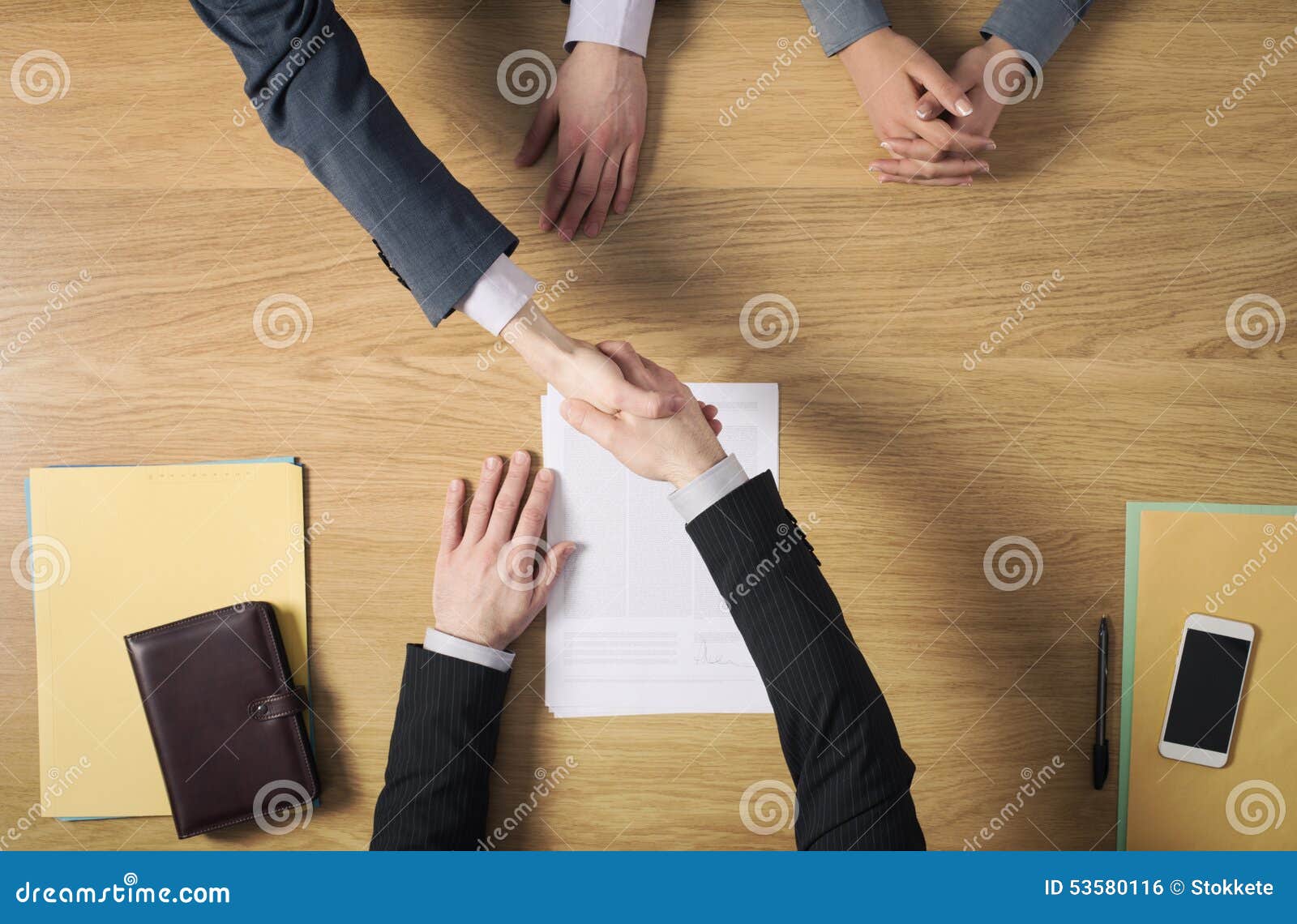 business people handshaking after signing an agreement
