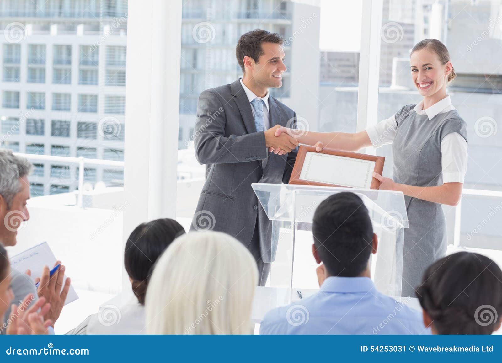 business-people-receiving-award-meeting-room-54253031.jpg