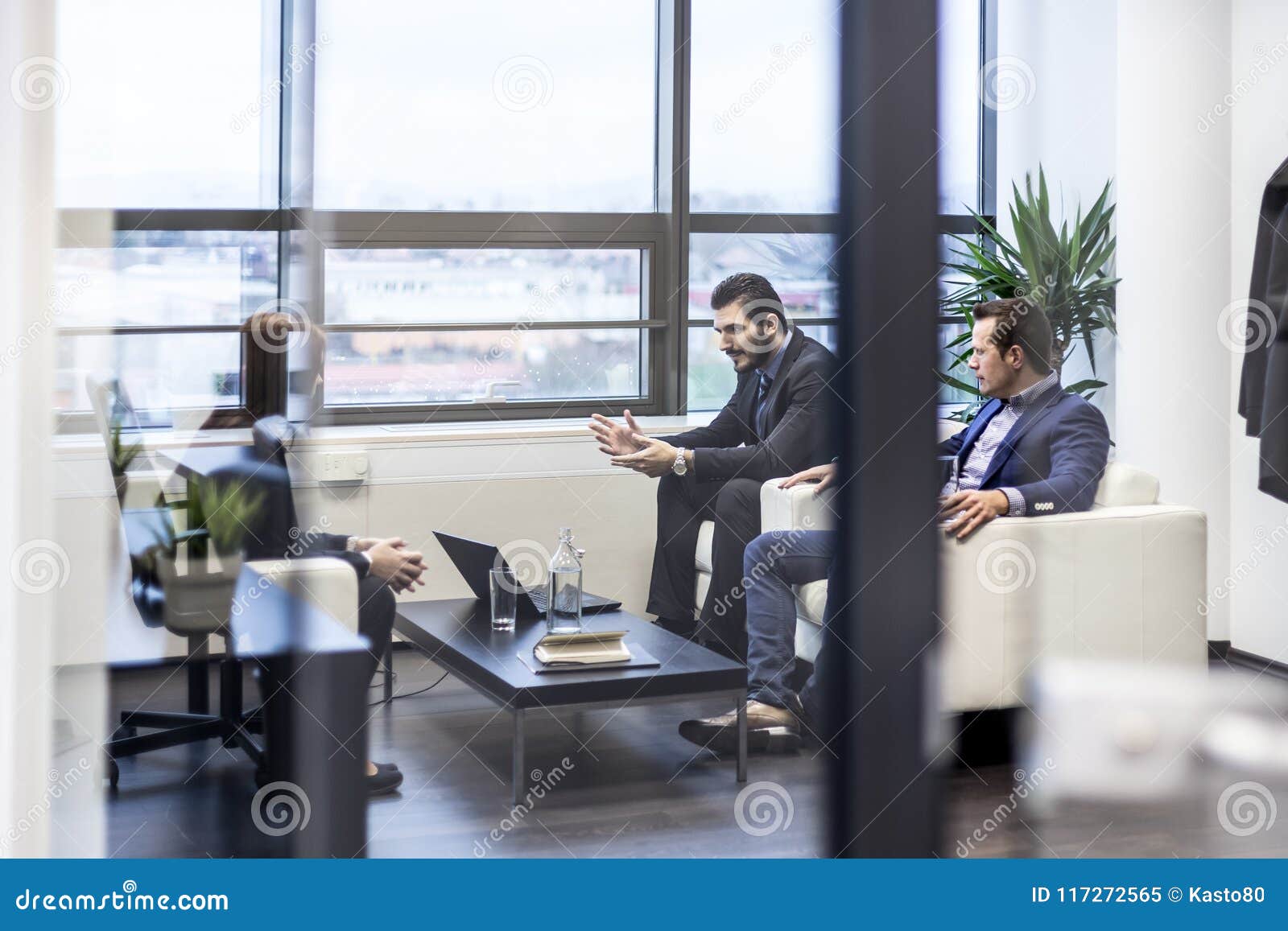 Business People Sitting at Working Meeting in Modern Corporate Office