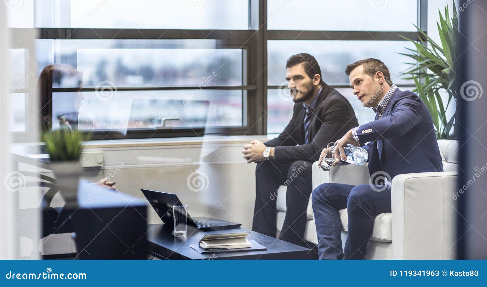 Business People Sitting at Working Meeting in Modern Corporate Office