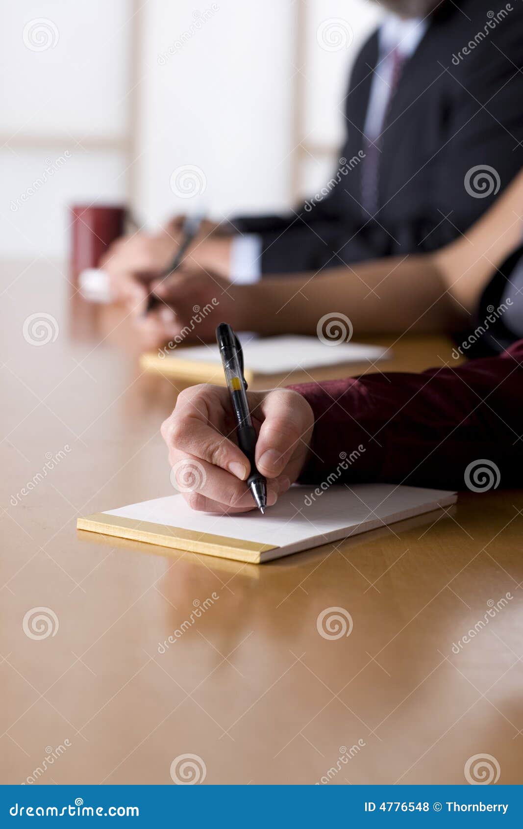 business people taking notes in a meeting