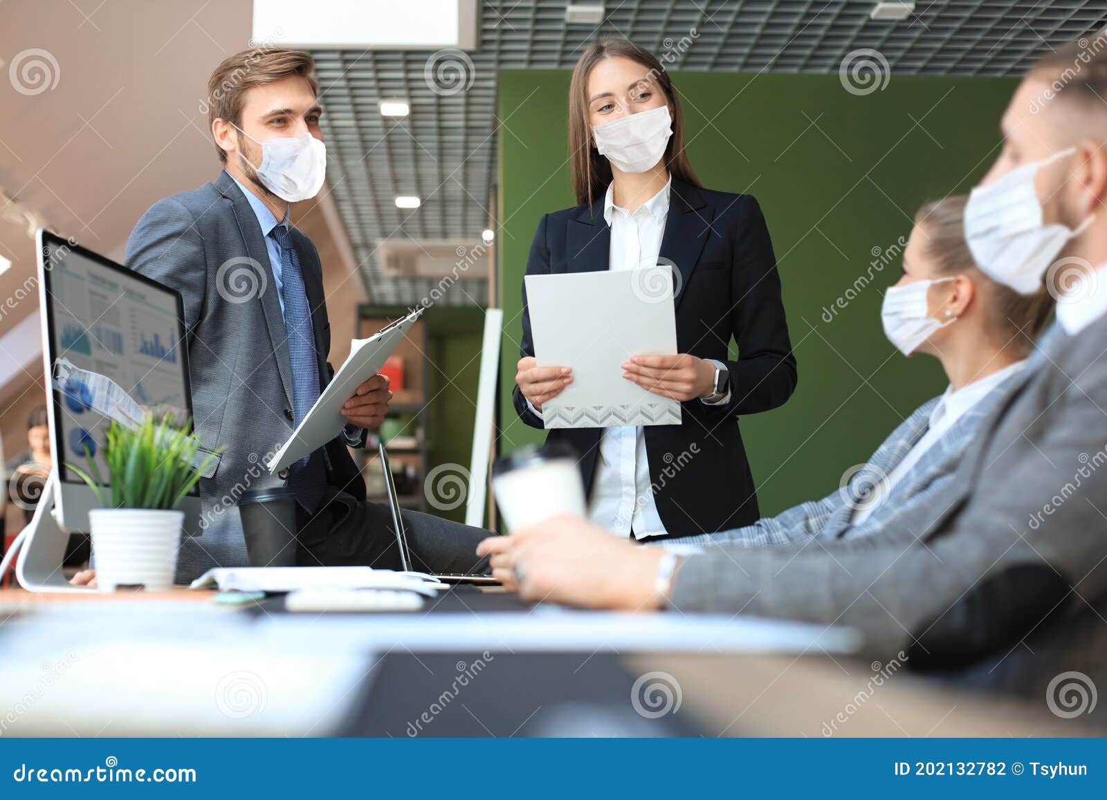 business people wear preventive masks during epidemy in office.