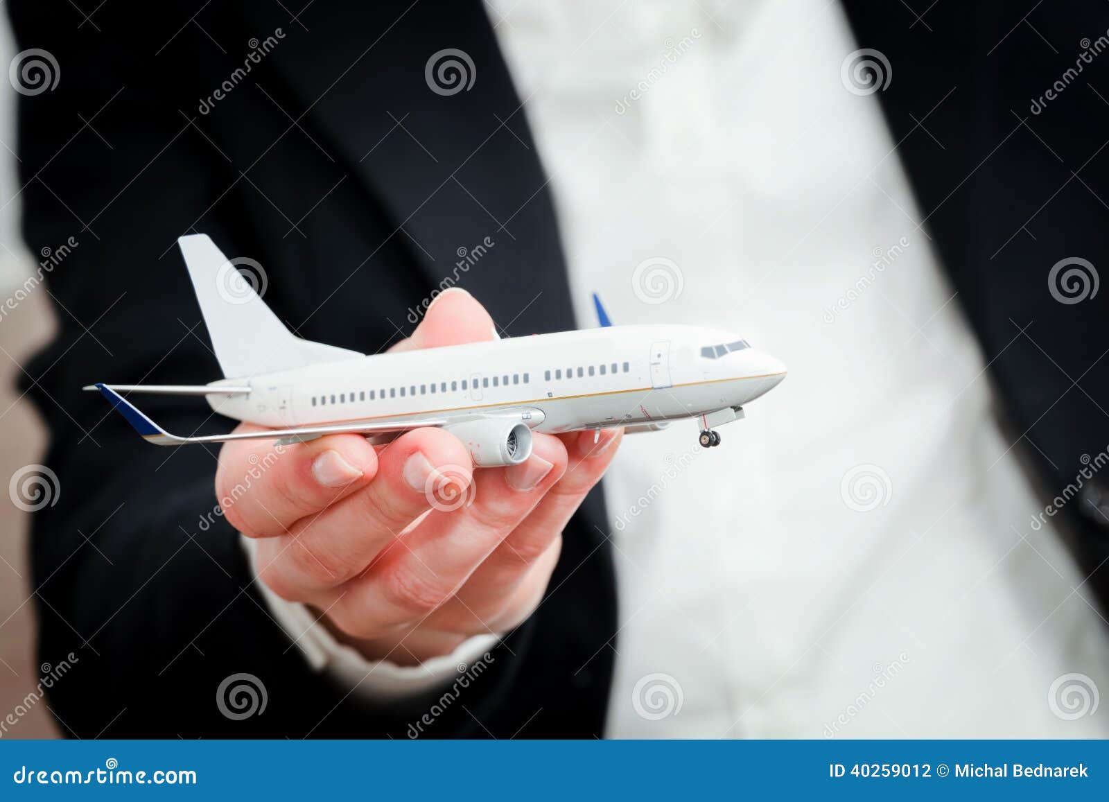 business person holding airplane model. transport, aircraft industry, airline