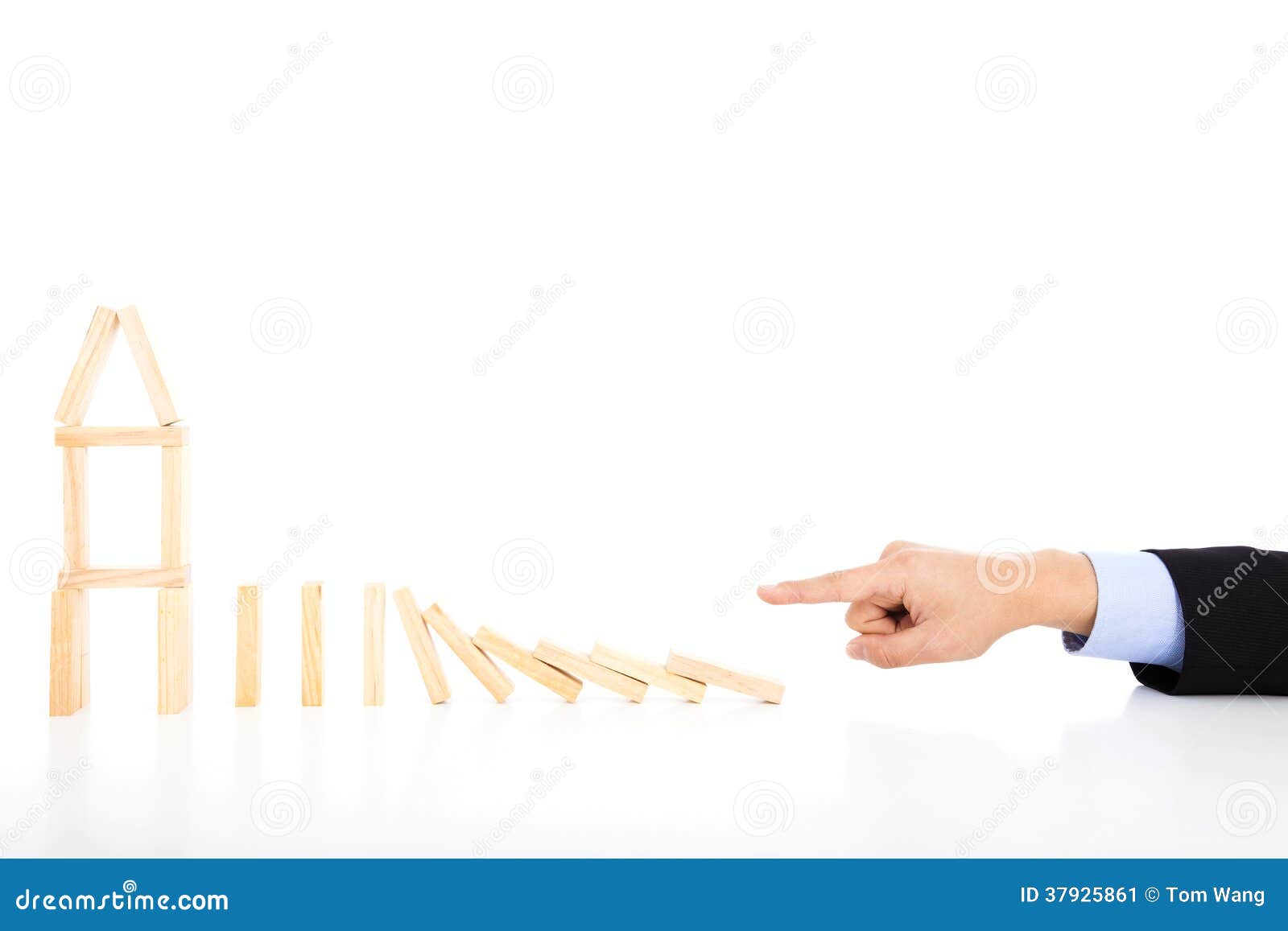 business person pushing dominoes to destroy house