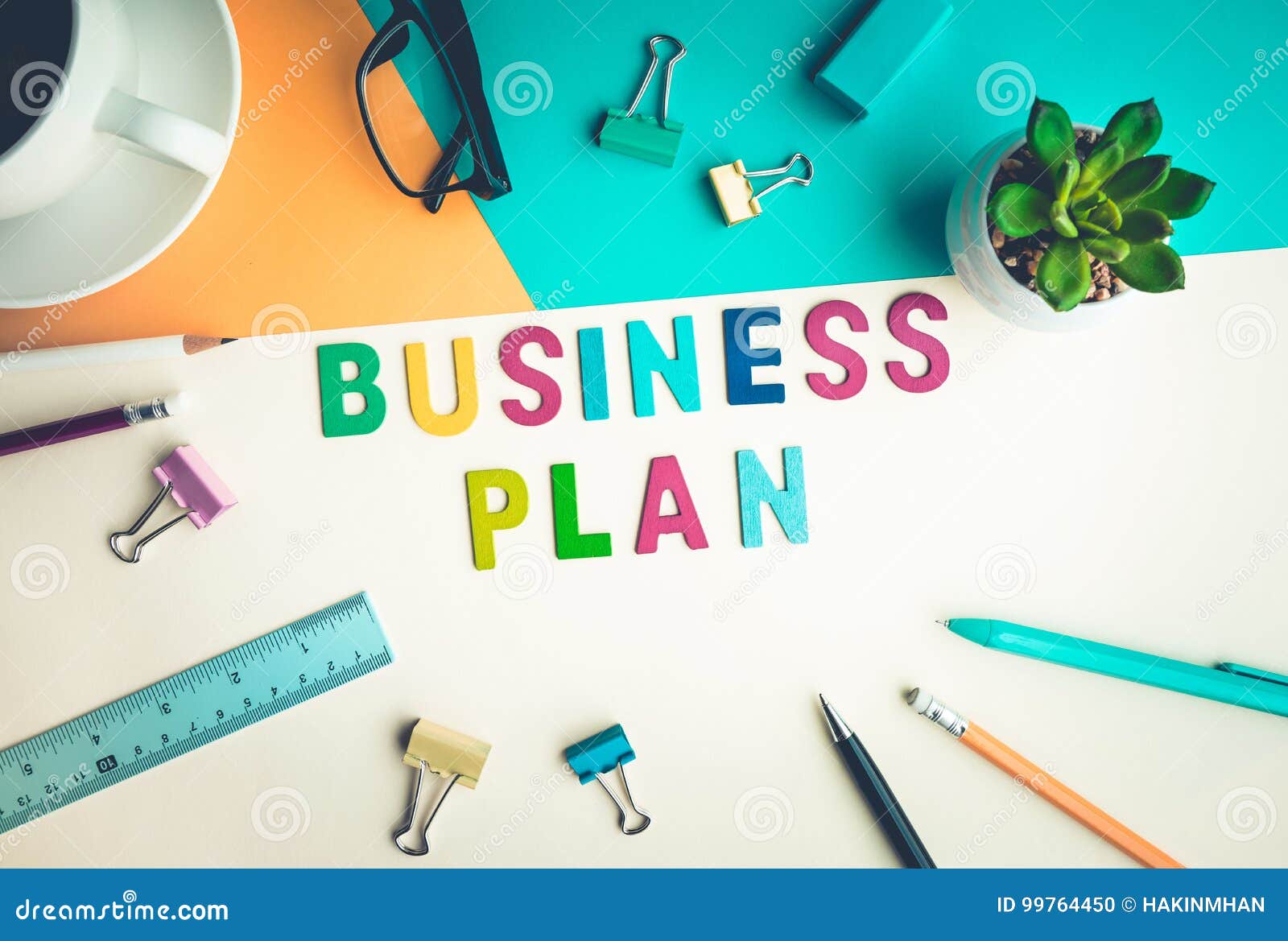 Business Plan Word on Desk Office Background with Supplies. Stock Photo