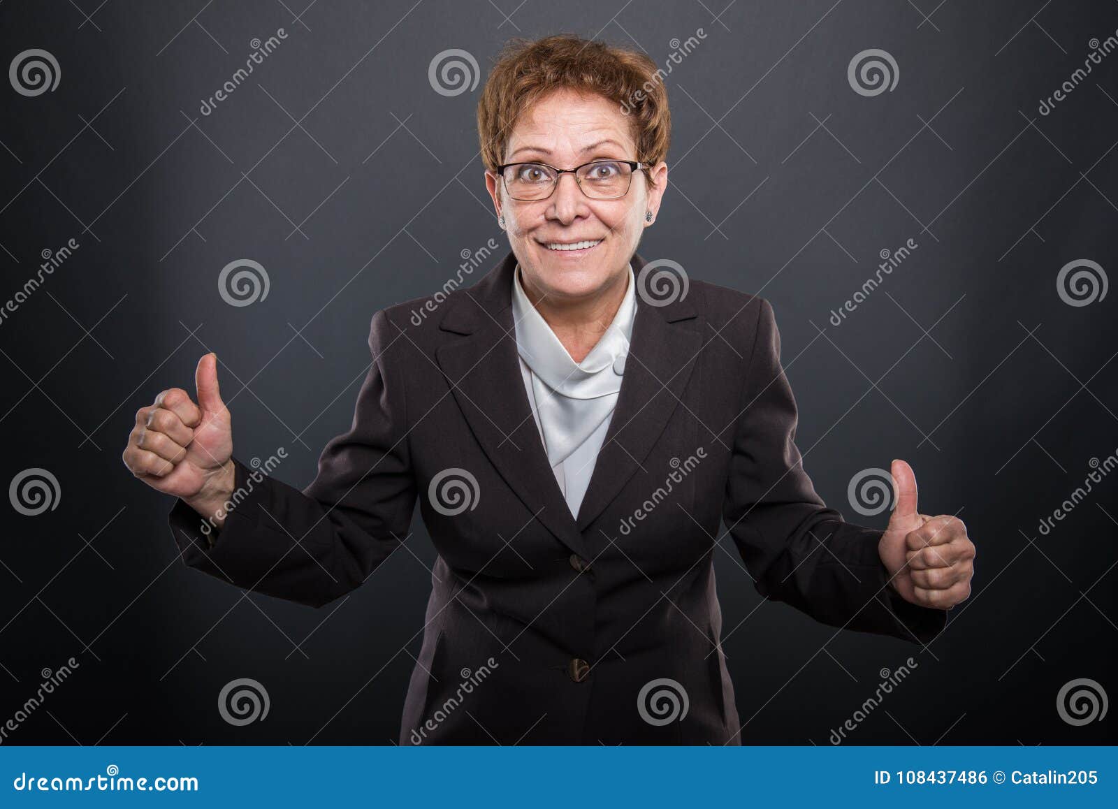 business senior lady showing like gesture with both hands