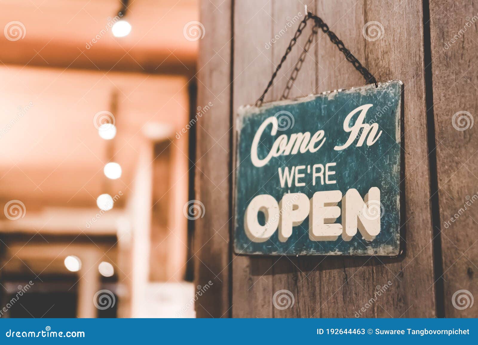 a business sign that says open on cafe or restaurant hang on door at entrance. vintage color tone style.