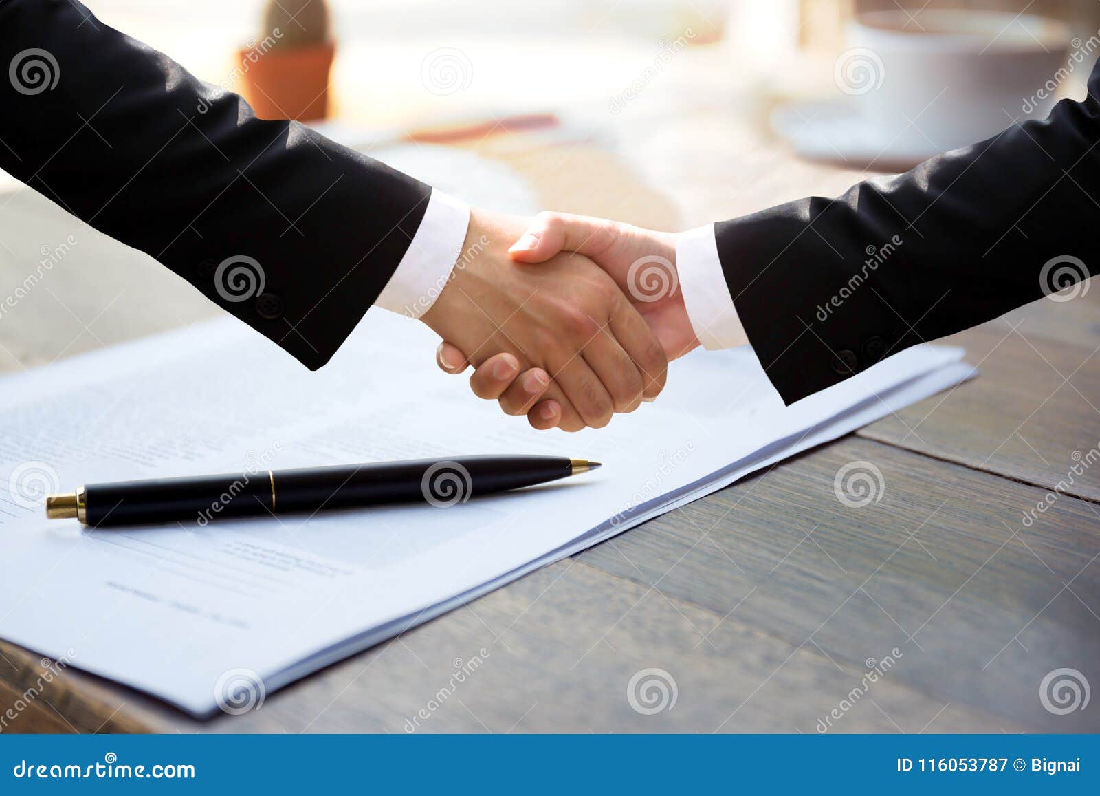 business successful hand shaking hands over agreement form