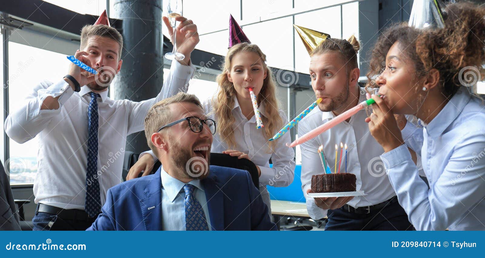 business team celebrating a birthday of collegue in the modern office