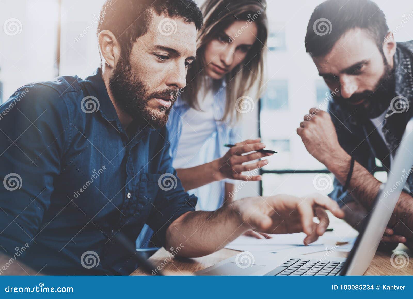 business team concept.young professionals discussing new business project in modern office.group of three people analyze