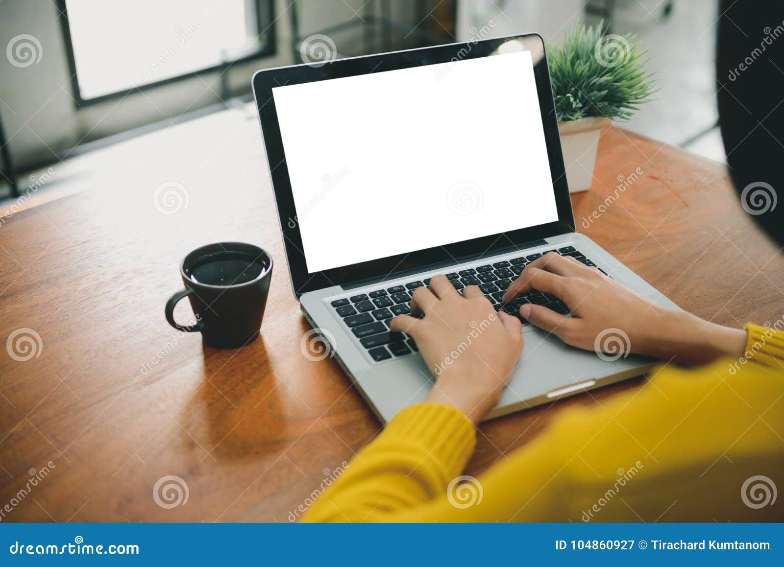digital lifestyle working outside office. woman hands typing laptop computer with blank screen on table in coffee shop.