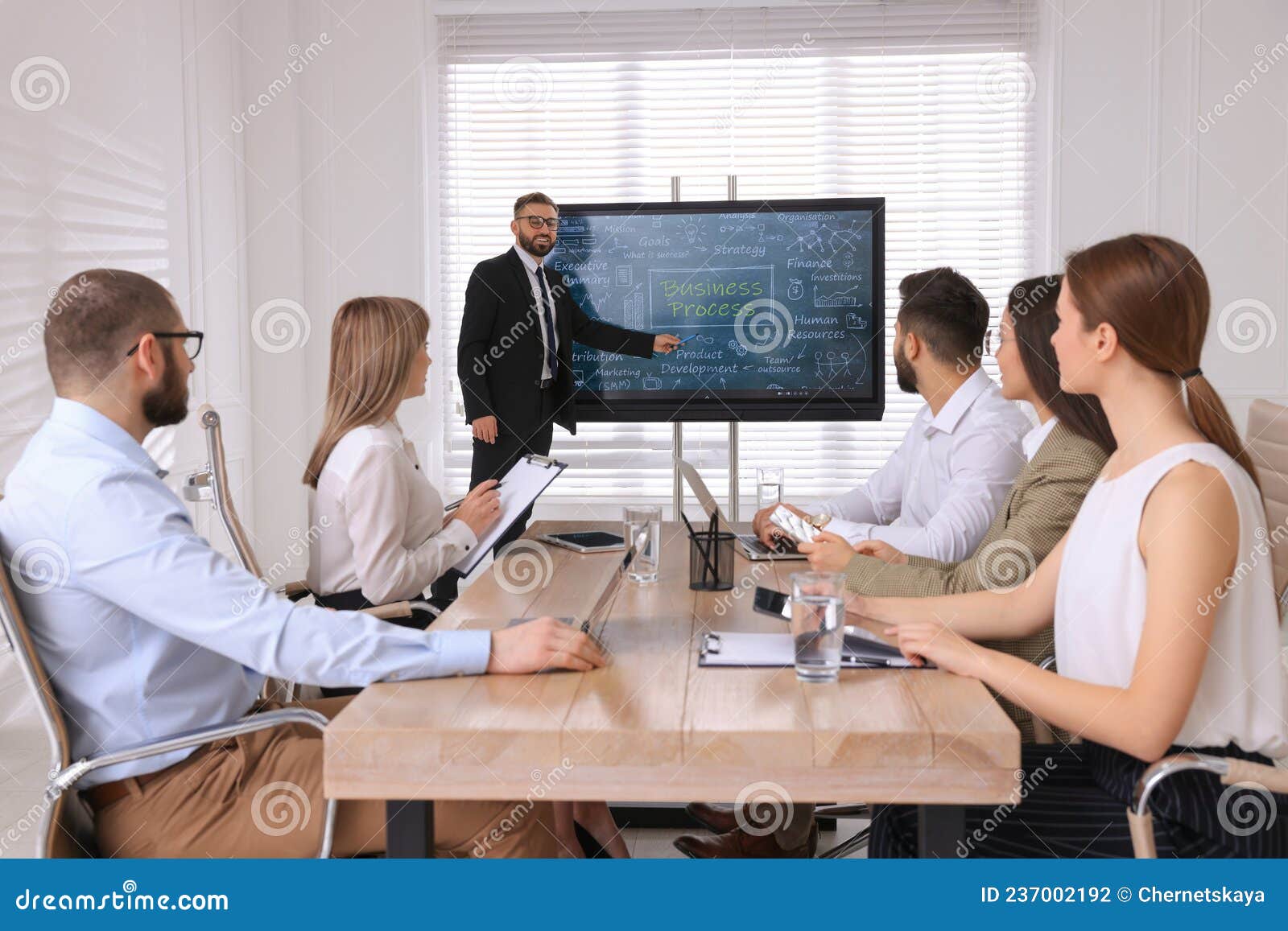 business trainer using interactive board in meeting room during presentation