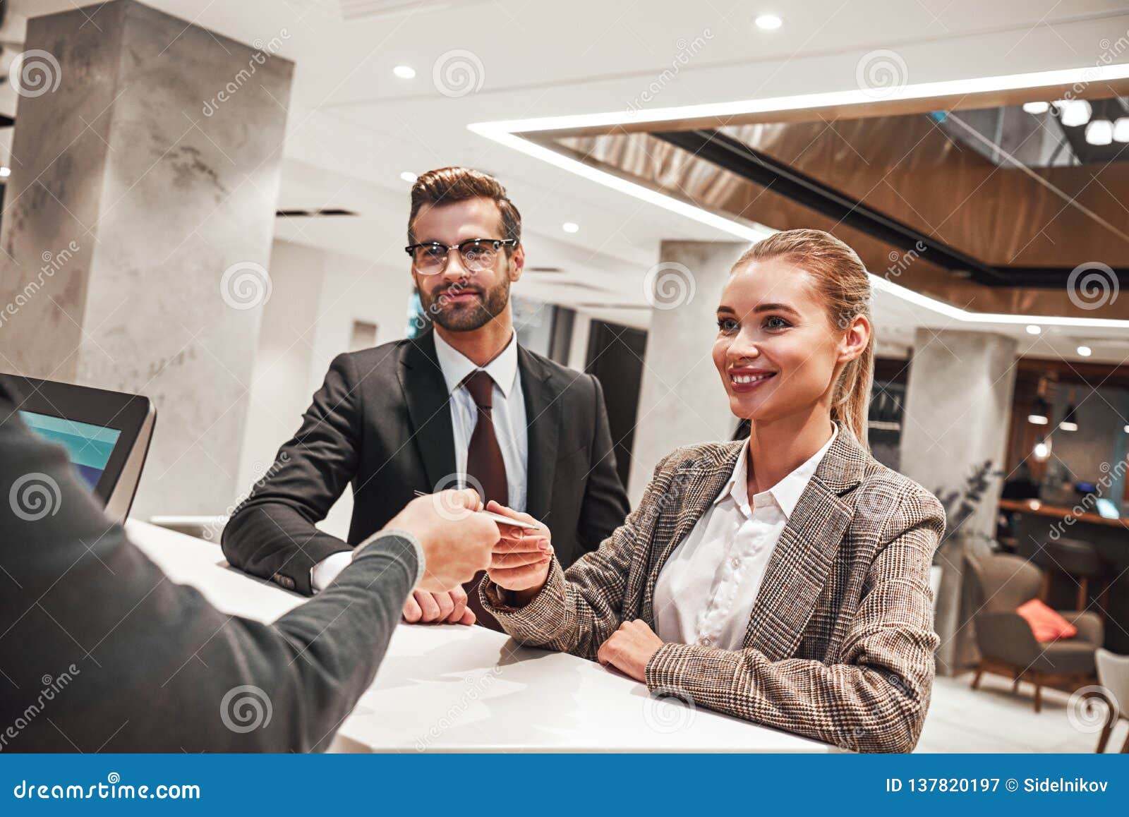 Couple on a Business Trip Doing Checkin at the Hotel Stock Image