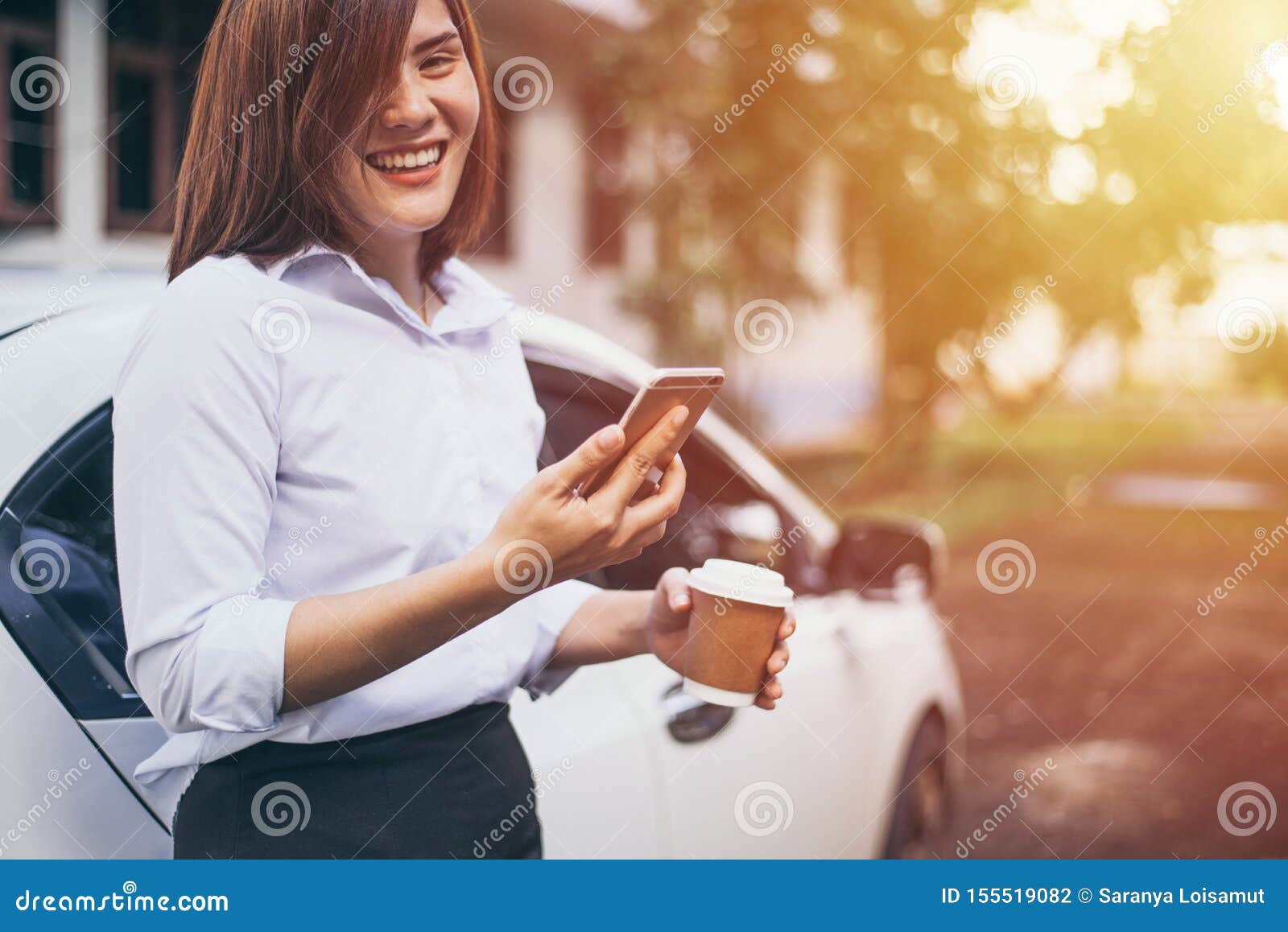 Business Woman Hand Holding A Coffee Cup To Take Away And Watching The Plans On The Smartphone ...