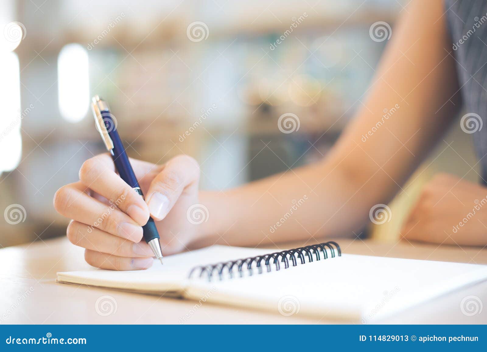 Business Woman Hand is Writing on a Note Pad with a Pen in Office ...