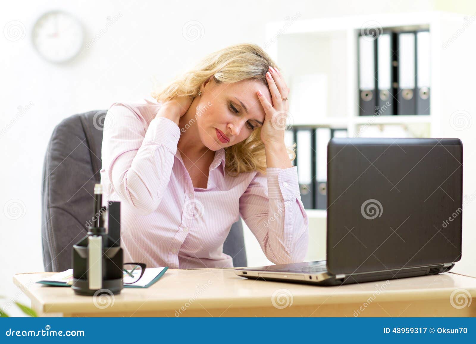 business woman with headache having stress in the office