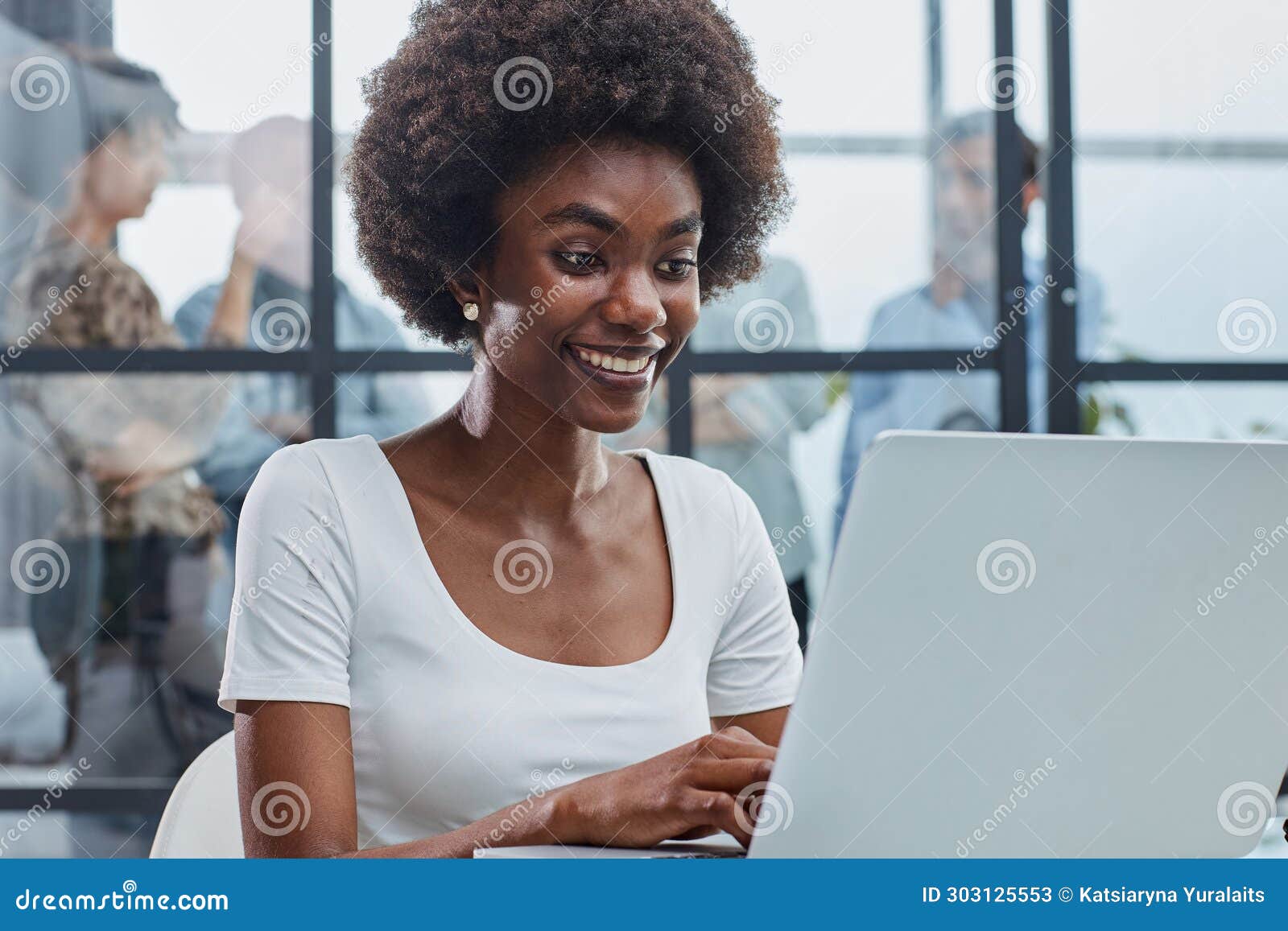 business woman with her staff in background at office