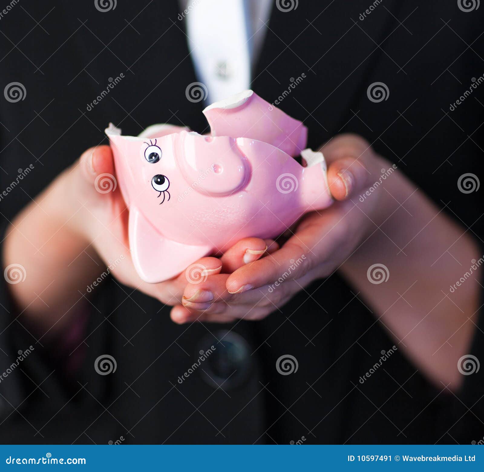 business woman holding a broken piggy bank