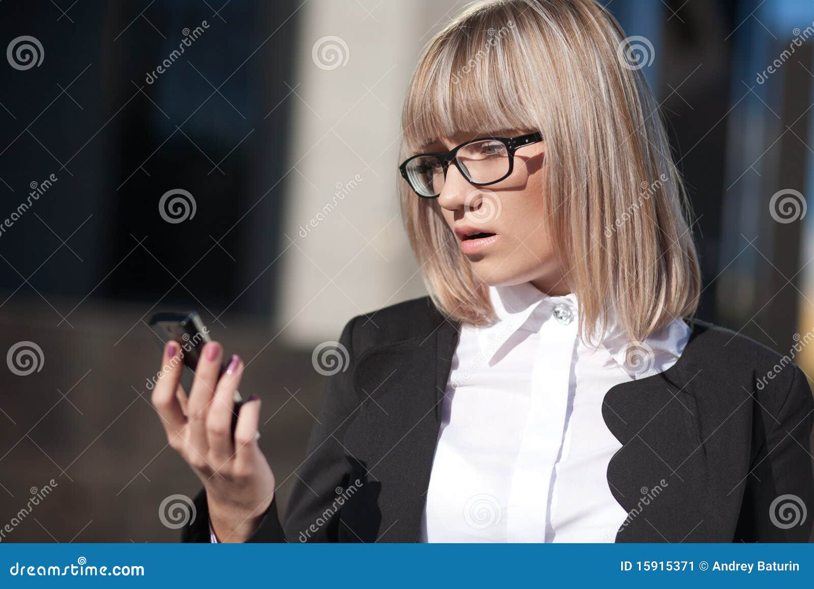 Business woman reading a text message on her cell phone