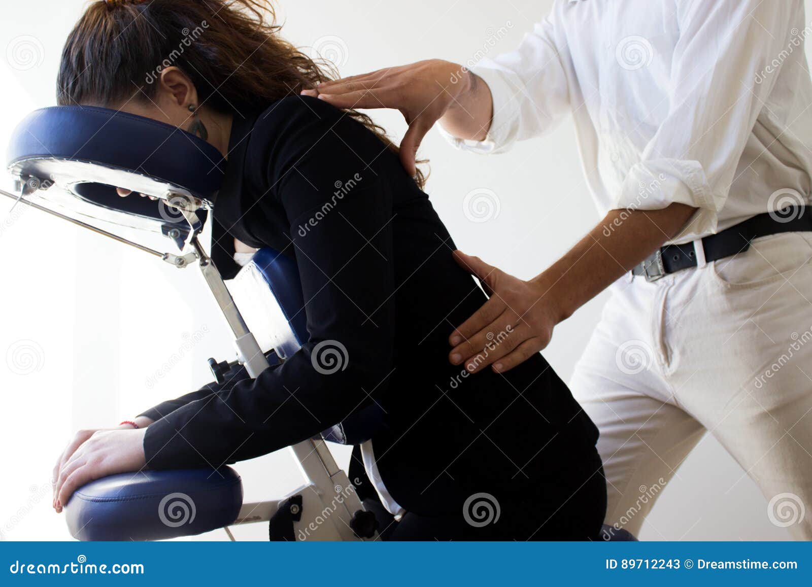 business woman receiving shiatsu on a massage chair