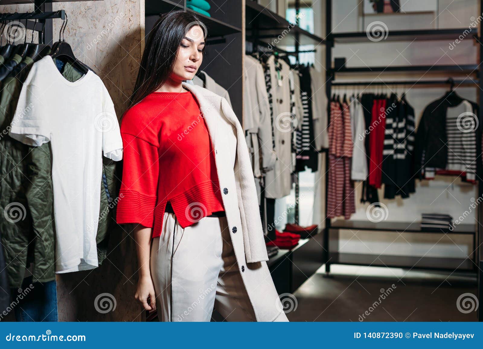 Business Woman in Red Sweater and Coat in Clothing Store Stock Photo ...