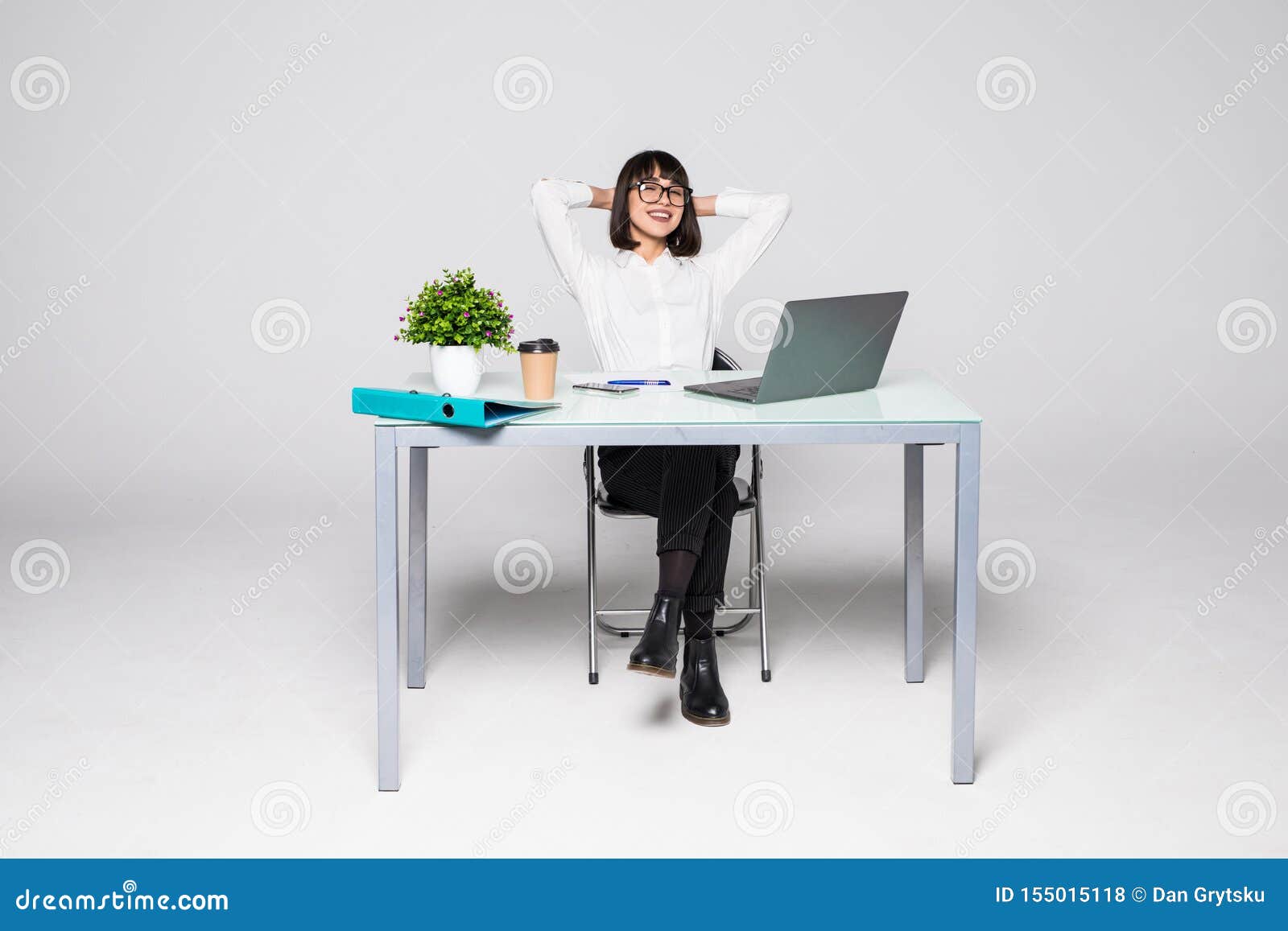 Business Woman Relaxing With Her Hands Behind Her Head And Sitting On