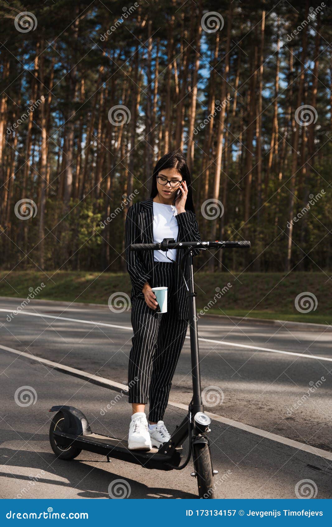 Business Woman Riding Electric Scooter at Parking Lot - Emission Free ...