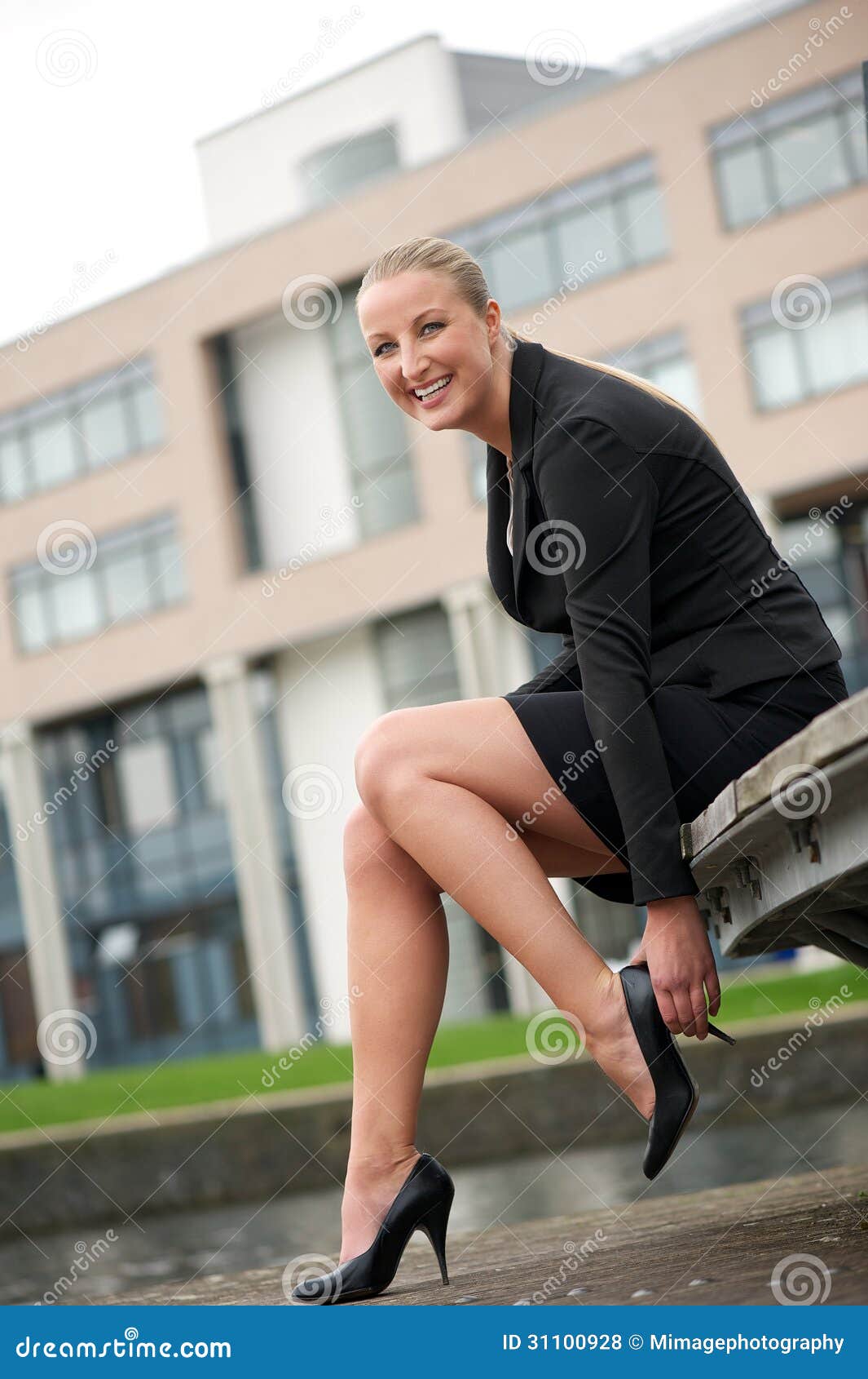 Business Woman Sitting and Adjusting Her Shoes Stock Photo - Image of ...