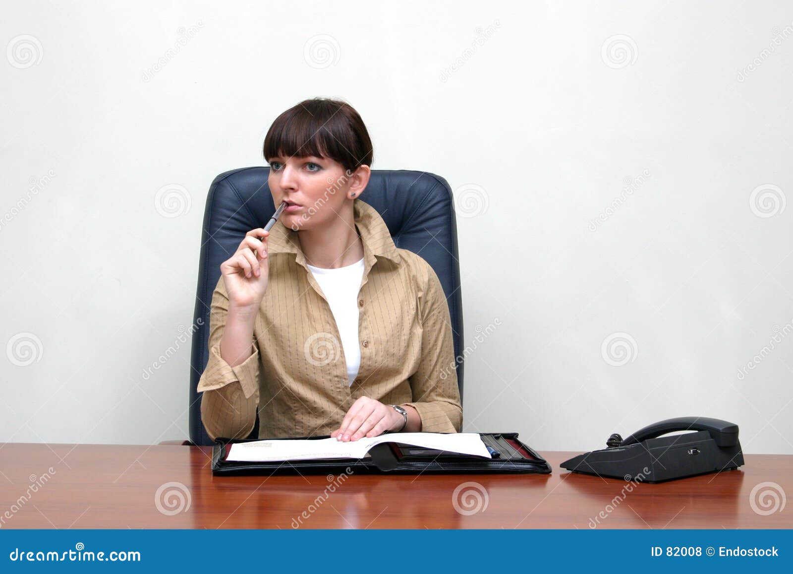 Business Woman Sitting Behind The Desk In The Office, Solving The ... Business Woman Sitting Behind The Desk In The Office, Solving The ...