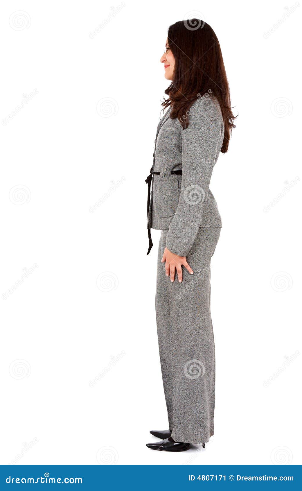 Photo about Business woman standing from the side isolated over a white bac...